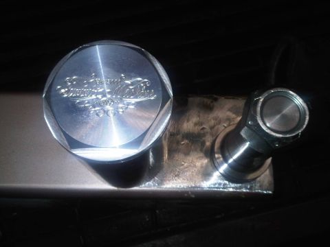 1996 Ford Bronco - A custom machined metal part with a hexagonal cap displaying engraved text.