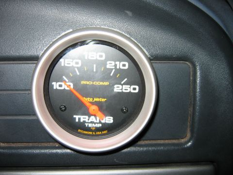 1992 Ford Bronco - A close-up of a transmission temperature gauge with an orange needle pointing to approximately 120 degrees Fahrenheit.
