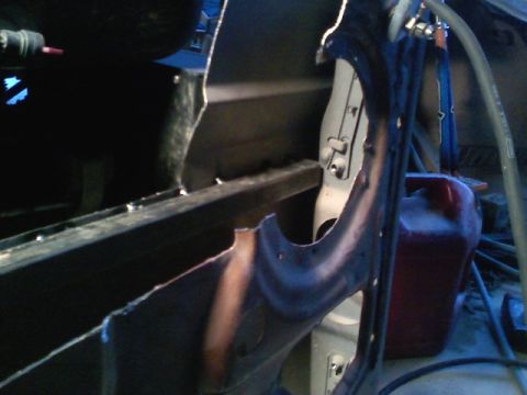 1990 Ford Bronco - Close-up view of an interior body panel, showing exposed metal and wiring details.