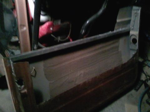 1990 Ford Bronco - Close-up view of a vehicle's interior, showing paneling and structural components.