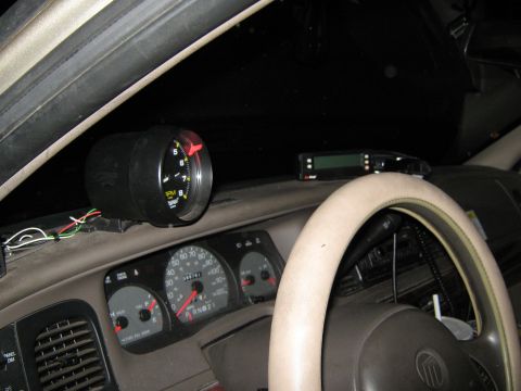 2000 Mercury Grand Marquis - The interior dashboard shows an aftermarket tachometer and the vehicle's original gauges.