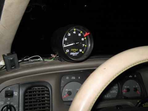 2000 Mercury Grand Marquis - Interior view of a dashboard a tachometer gauge and part of the steering wheel.