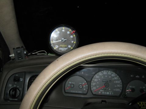 2000 Mercury Grand Marquis - Aftermarket tachometer installed on the dashboard next to the speedometer.