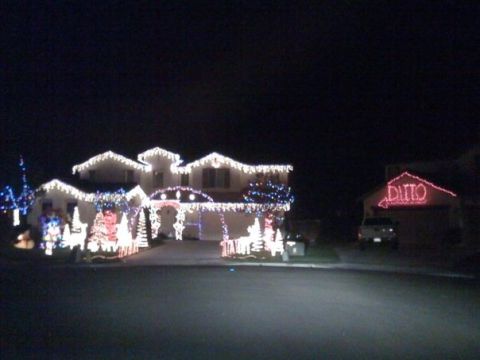 2006 Ford E350 - A house is adorned with numerous Christmas lights, and a neighboring garage displays the word DITTO in illuminated red letters.