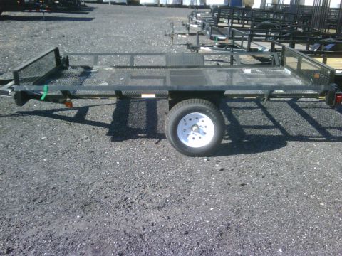 2004 Ford F-150 - A utility trailer is shown from the side, a mesh railing and a diamond plate floor.