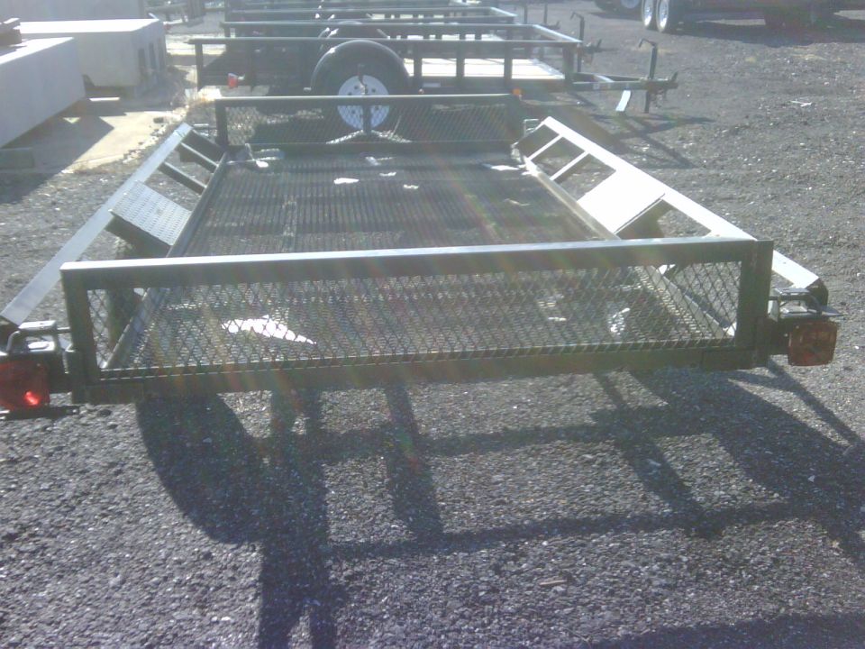 Trailer with mesh deck and metal rails, seen from rear