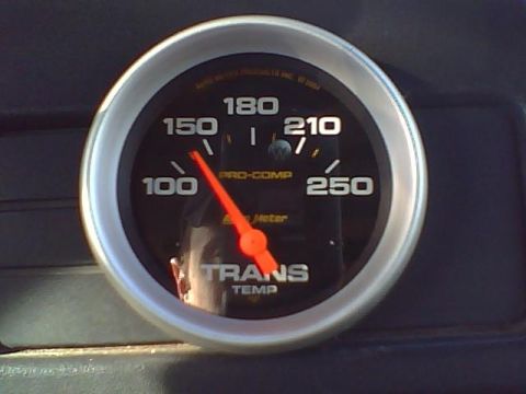 1992 Ford Bronco - A Pro-Comp transmission temperature gauge shows the needle indicating 120 degrees.