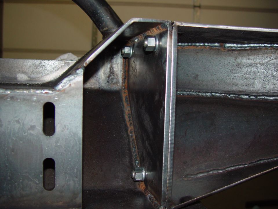 Close-up of welded steel frame components with hex bolts