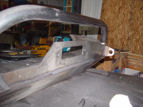 1993 Ford Bronco - A custom metal bumper part is shown in a workshop setting with tools and materials in the background.