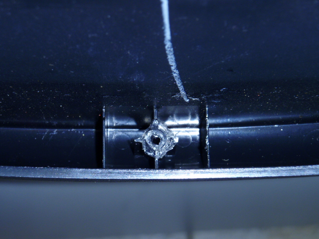 While replacing the rear window switch, I broke all three retaining clips from the backside of the bezel.  After 30 minutes of waiting for the glue to try, which didn't work, I figured something else out.