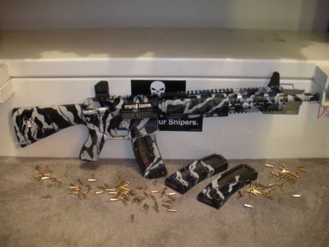 1996 Ford Bronco - A rifle with a unique camouflage pattern is displayed with spare magazines and loose ammunition on a carpeted surface.
