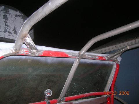 1985 Ford Bronco - Custom roll cage welded to red windshield frame with a gauge visible. Date stamp reads 12.23.2009.