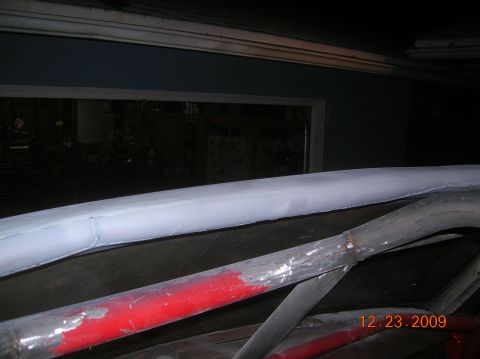 1985 Ford Bronco - Interior view of a vehicle's roll cage, showing metal bars with red and gray paint.