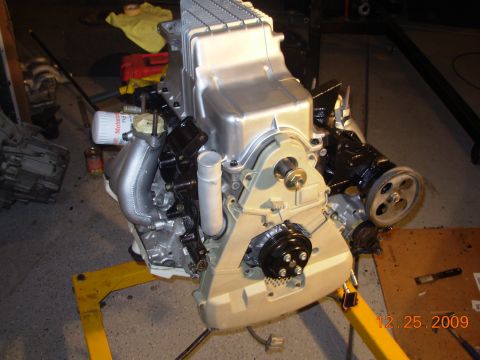 1991 Ford Taurus - Engine assembly on a yellow stand, showing the oil pan and various engine components.