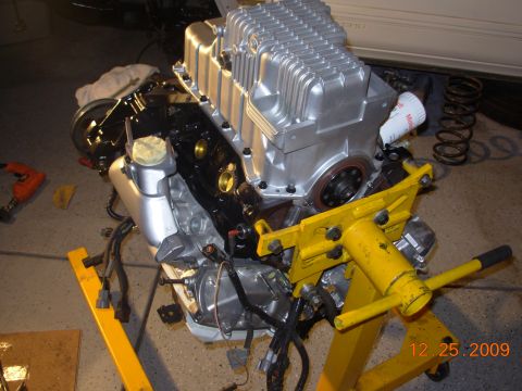 1991 Ford Taurus - Engine assembly on a stand, with an oil filter and wiring harness visible. Date stamp is 12.25.2009.