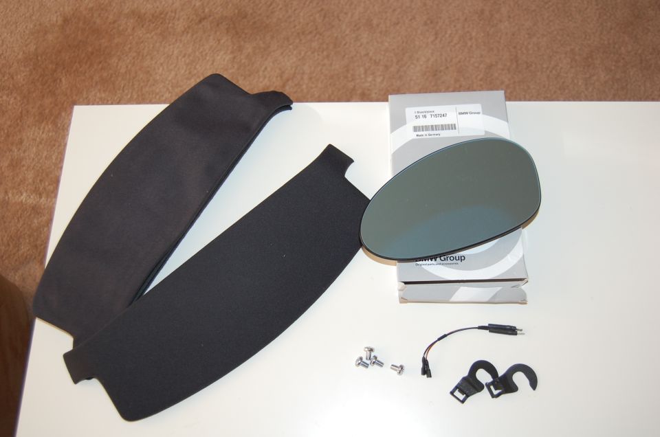 BMW mirror glass in branded box with black trim panels, bolts and wiring pigtail