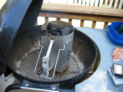 1992 Ford Bronco - A Weber charcoal chimney starter filled with briquettes sits inside a kettle grill, ready for use.