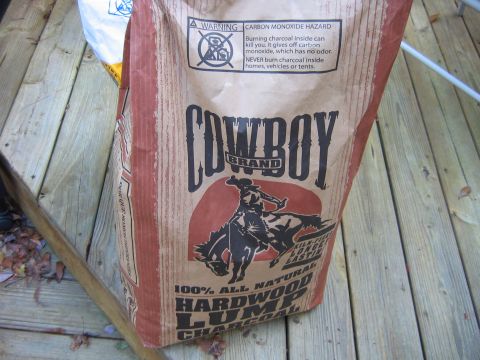 1992 Ford Bronco - A bag of charcoal sits on a weathered wooden deck, with a warning about carbon monoxide hazards.