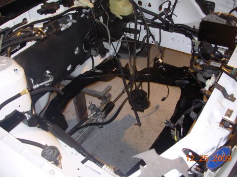 1991 Ford Taurus - The engine bay is partially disassembled, showing frame and wiring during a project.