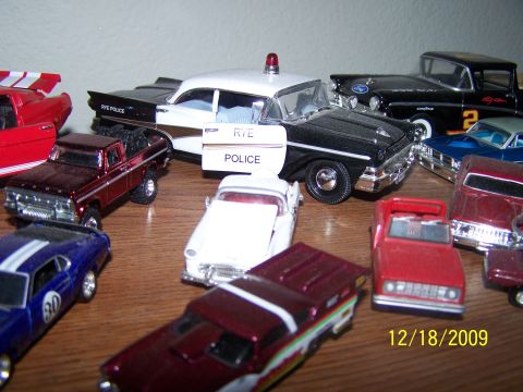 1972 Ford Ranchero - A collection of various toy cars are displayed on a wooden surface, with a date stamp of 12/18/2009.