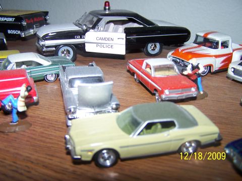 1972 Ford Ranchero - A collection of various toy cars are displayed on a wooden surface, with a date stamp of 12/18/2009 in the corner.
