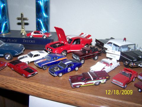1972 Ford Ranchero - Various toy cars and trophies are displayed on a wooden shelf, captured in a photograph from 2009.