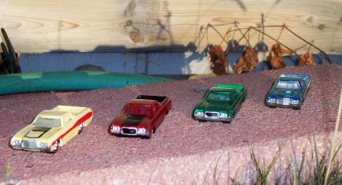 1972 Ford Ranchero - A collection of toy vehicles, including a Ranchero, are displayed on a miniature landscape.