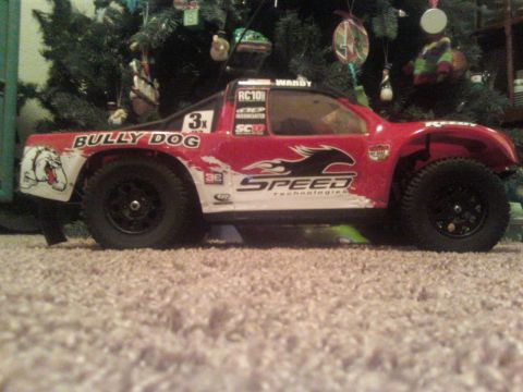 1984 Ford Bronco - RC truck with racing decals sits on carpet in front of a Christmas tree.