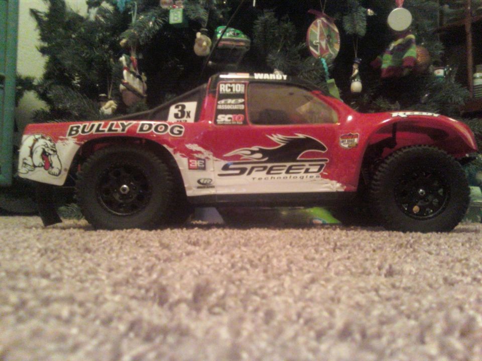 Red remote control truck with "BULLY DOG" and "SPEED Technologies" graphics