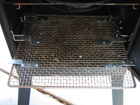 1992 Ford Bronco - Close-up of a metal smoker rack, showing its construction and some accumulated debris.
