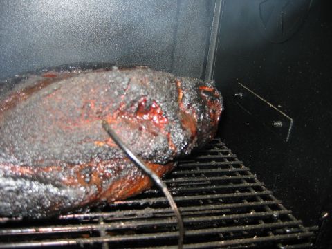 1992 Ford Bronco - Meat cooking on a grill rack inside a smoker with a thermometer probe inserted.