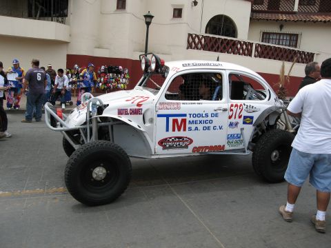 1986 Ford Bronco - Modified Volkswagen Beetle race car with sponsor logos and number 572 visible.