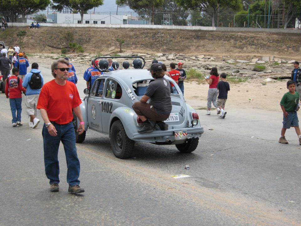 Gray Volkswagen Beetle with racing decals and number 1402, rear view, modified for off-road