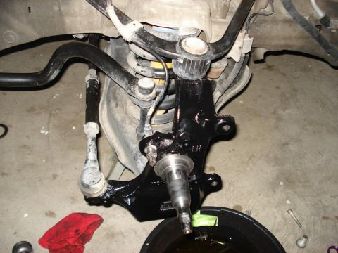 2007 Ford Mustang - Front suspension knuckle and related components, likely during a repair or upgrade.