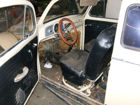 2000 Ford E350 - Interior view of a classic car showing worn seats, dashboard, and door panel.