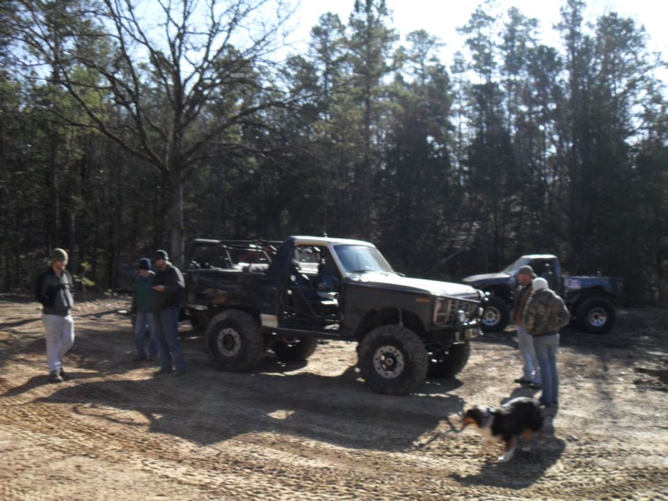 Modified SUV with lifted suspension and off-road tires, parked outdoors