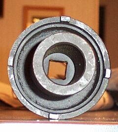 1990 Ford Bronco - Metal part with a square drive opening, likely a tool or component. Supermotors.net logo is present.