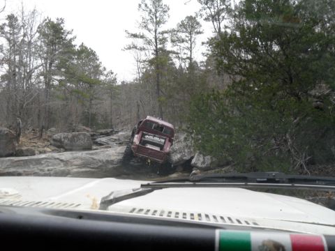 1986 Ford Bronco - Red 1986 Ford Bronco tackling a challenging rocky off-road course.