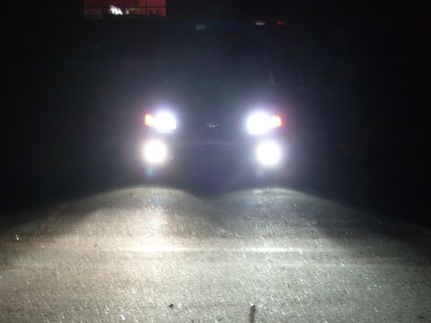 1992 Ford Bronco - Headlights shine brightly on a dark road, illuminating the path forward.