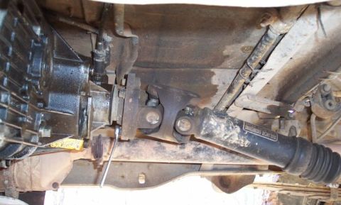 1990 Ford Bronco - Here you see the wrench on one of the bolts at the t-case flange