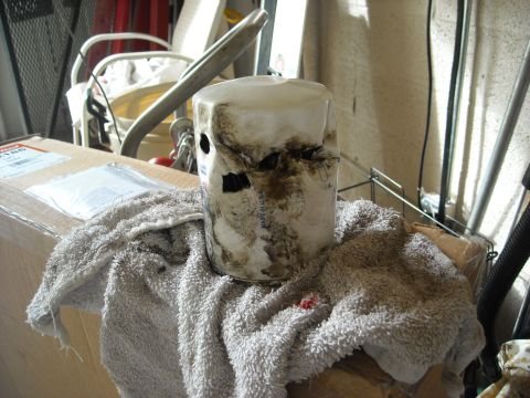 1992 Ford Bronco - A dirty oil filter sits on a towel, with a box and garage background visible.