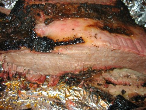 1992 Ford Bronco - A close-up view of a large piece of smoked brisket, showing the bark and pink smoke ring.
