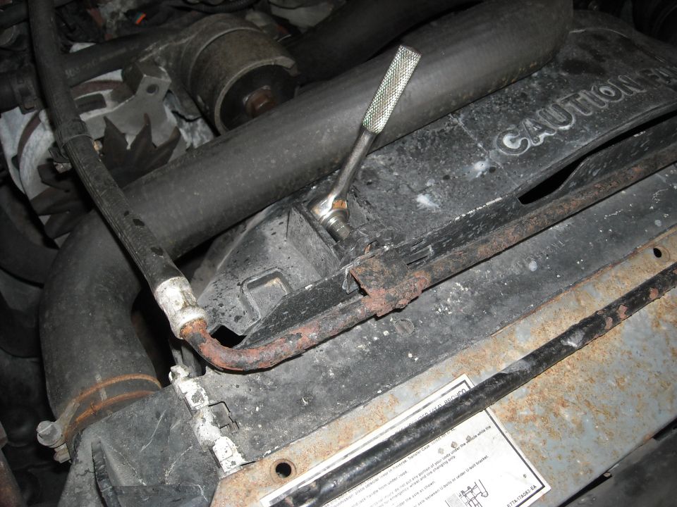 We also have two bolts along the top. these hold in this coolant line which goes to the intake and it also helps hold the fan shroud on