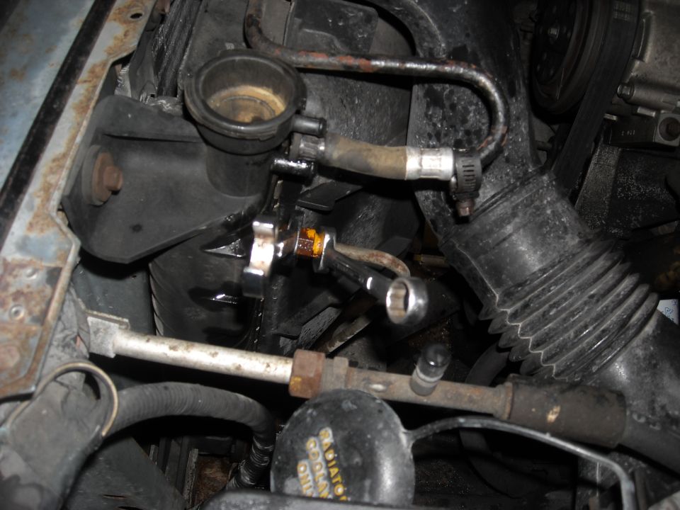 Here you will need a 5/8 and a 1/2 inch line wrench.
The key is to hold the 5/8 still while taking the smaller one off.
I thought that the bigger 5/8 part needed to come out so this was 45 minutes wasted.
Had I looked at my new radiator first, it would have saved me a lot of aggravation