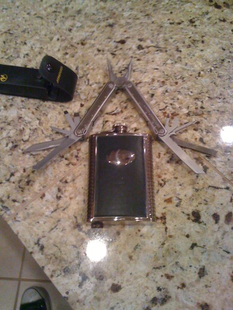1968 Ford Mustang - A multi-tool is opened and positioned above a flask on a granite countertop.