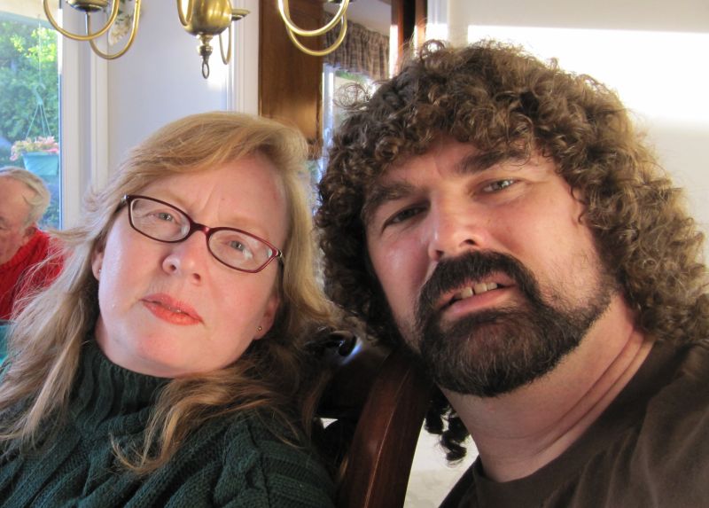 Woman with glasses and man with curly hair and beard
