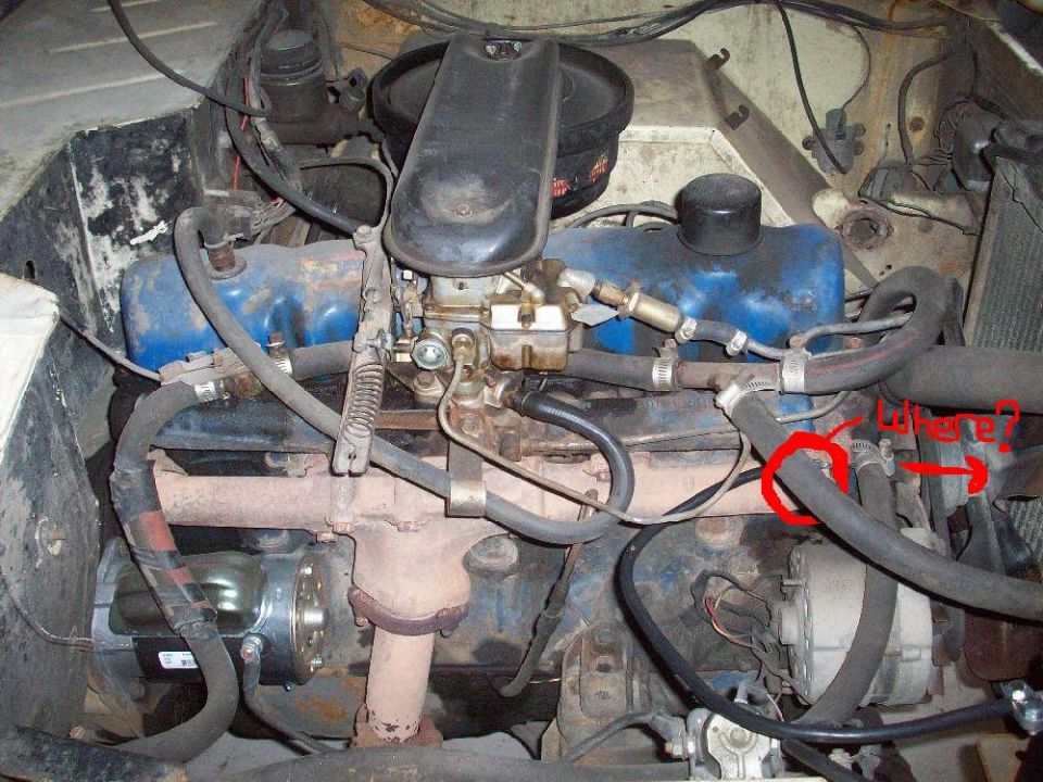 Engine bay showing V8 engine components, hoses, and wiring. A red circle highlights a hose connection