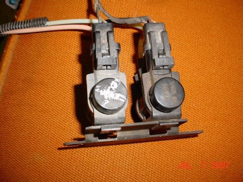 2007 Ford Mustang - Close-up of two electrical connectors with sensors, one marked 'Made in USA'.