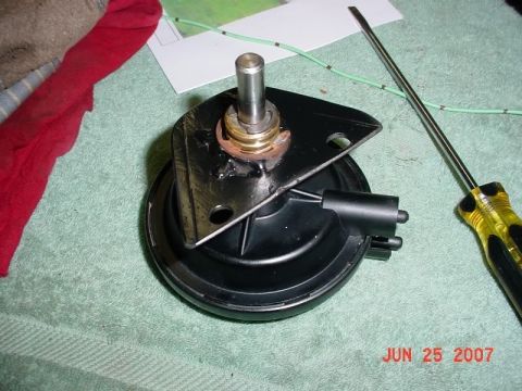 2007 Ford Mustang - A car part sits on a towel next to a screwdriver and a red cloth.