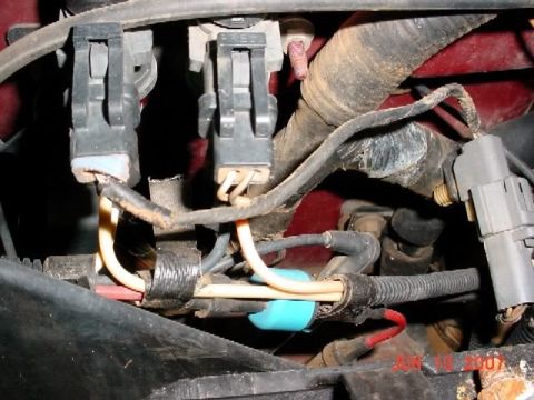 2007 Ford Mustang - Close-up view of a vehicle's engine wiring harness, showing various connectors and wires.
